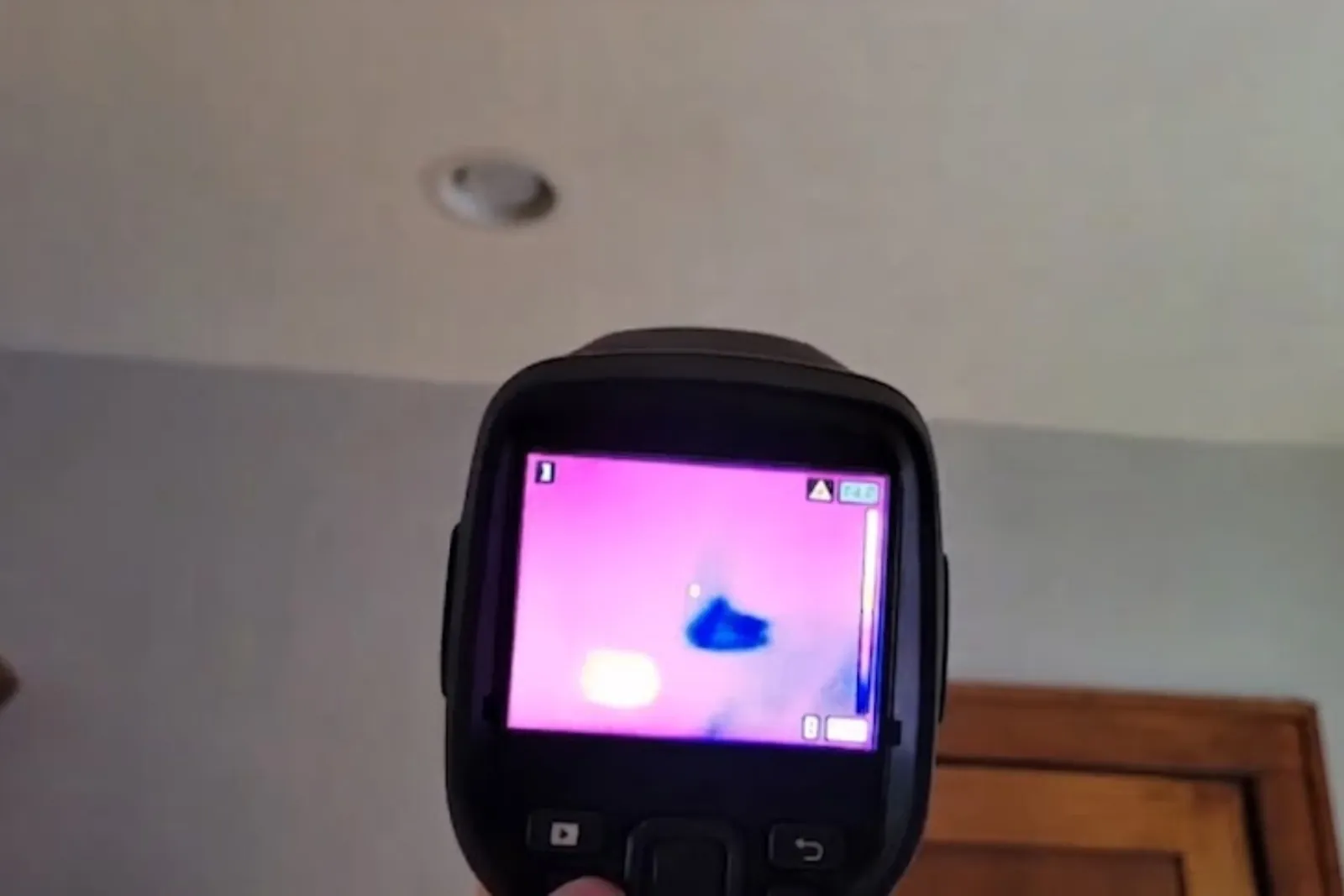 Thermal imaging camera showing a hidden wet spot on a wall